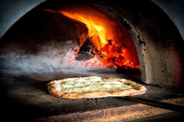 <img alt= " Pizza in Wood Fired Oven">