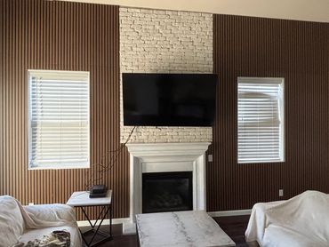 Contemporary vertical striped wood paneling installed on a large wall. Turned out amazing.
