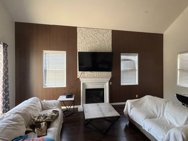 Contemporary vertical striped wood paneling installed on a large wall. Turned out amazing.