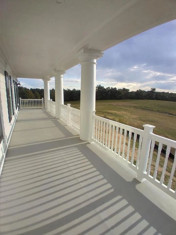 Beautiful plantation modern wrap around porch with white pickets built by Newkirk contracting in Md