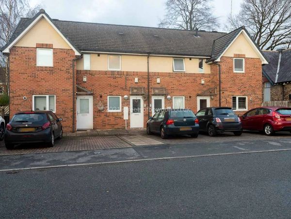 Modest town houses with cars parked in front