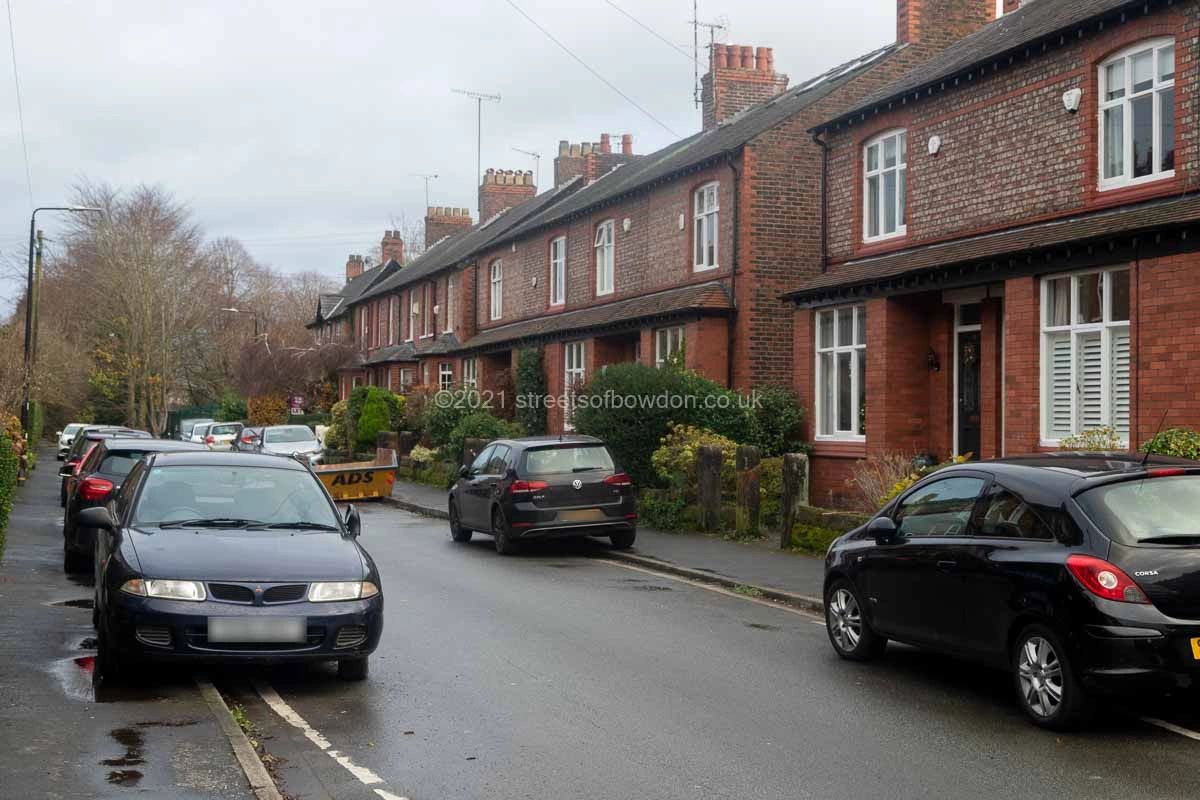 Street of terraced housing with cars parked on pavements