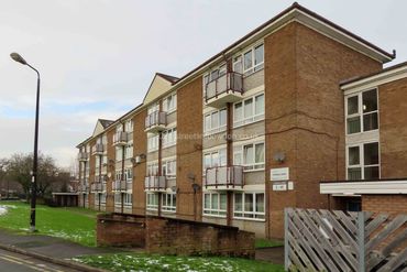 Block of flats with balconies and numerous satellite dishes