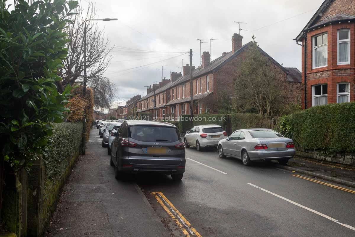 Street of terraced housing with cars parked on pavements