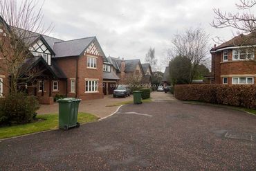 End of cul de sac with green bins out for collection