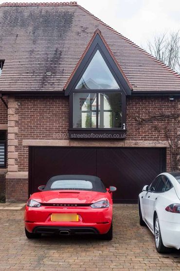 Red and white cars parked in front of double garage