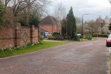 Road with decorative brick wall on left