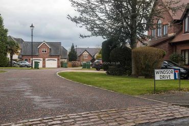 "No through road" sign with houses in background