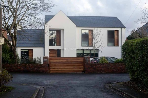 Modern dwelling behind wooden gate