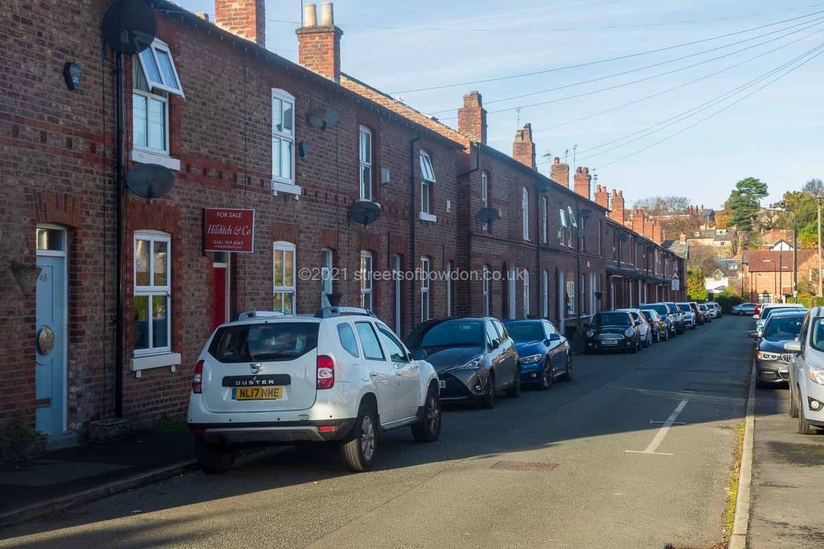 Traditional terraced housing with parked cars