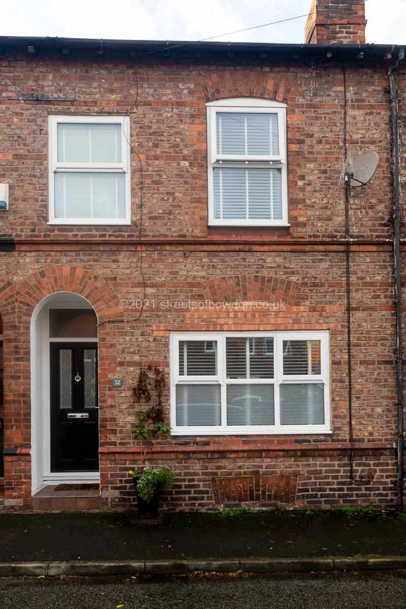 Neat terraced house with satellite dish