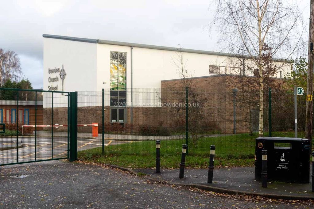 Modern school behind wire fencing
