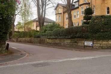 Road junction with apartment blockand detached house