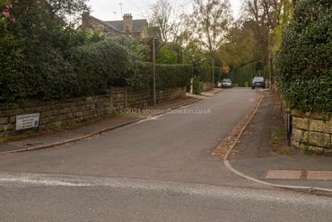 View down cul de sac with parked vehicles