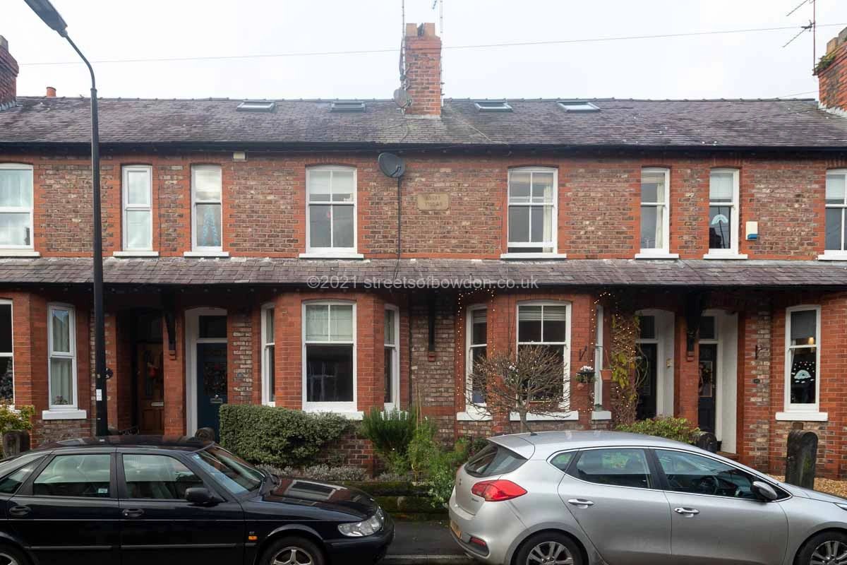 Neat terraced housing with cars parked in front