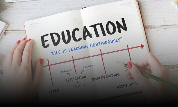 Education written on notebook with timeline and red arrow 