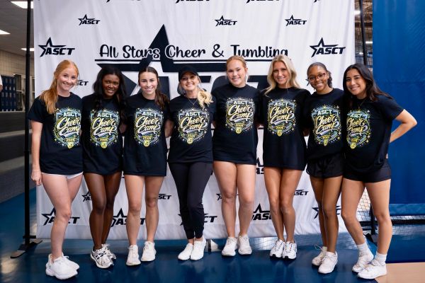 Group of eight women posing at All Stars Cheer & Tumbling event.