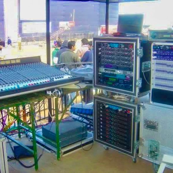 Professional audio mixing and sound equipment setup at an outdoor event.
