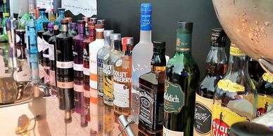 A selection of spirits on a copper back bar.