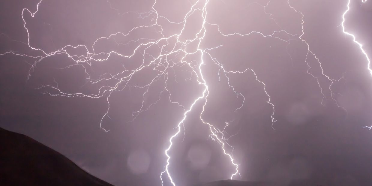 Multiple lightning bolts striking during a stormy night.