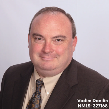Professional headshot of Vadim Danilin in a suit.