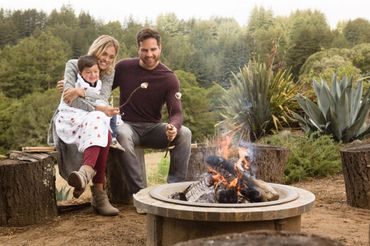 Family roasting Marshmallows at a campfire