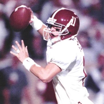 Football player in action preparing to throw a pass.