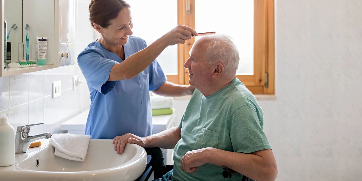 In home caregiver assists client with morning routines.