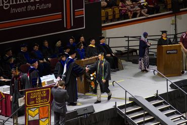 Graduate walking across the stage.