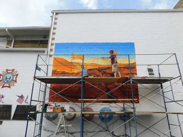 Lori and Mark painting the second layer on outdoor Mount Carmel VFW mural, America the Beautiful.