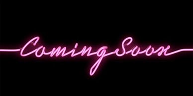 Neon pink sign reading 'Coming Soon' on black background.