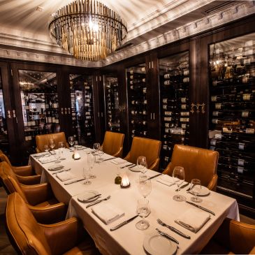Elegant dining room with leather chairs and wine cabinets.