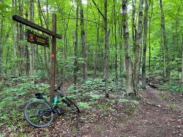 Floodwood Mountain Trailhead with bicycle resting against the sign
