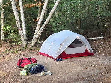 Tent set up with gear to the side