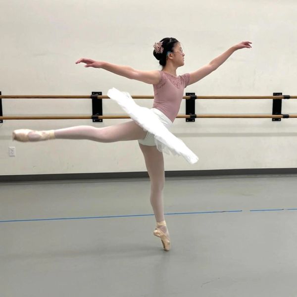 Ballet dancer striking a pose in studio.
