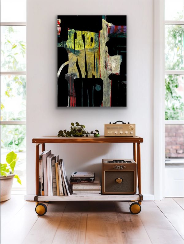 Abstract painting above a wooden cart with books and speakers.