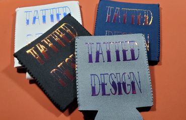 Four colorful fabric holders with 'TATTED DESIGN' text on an orange background.