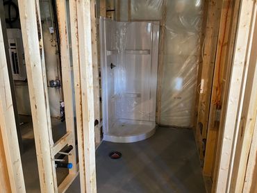 New shower stall installed during basement bathroom development
