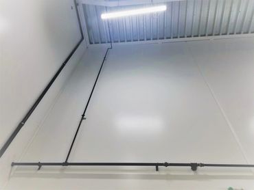 Gas line installed vertically on large wall in commercial property