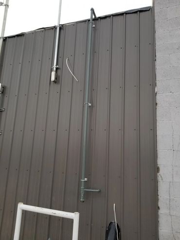 gas line running up exterior wall to roof top heater