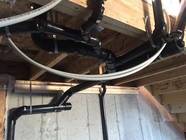 Pex Plumbing Pipes Exposed In Ceiling During Rough-In Stage Of Construction
