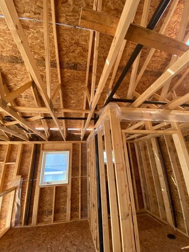 Pex Plumbing Pipes Exposed During Rough-In Stage Of Construction In Calgary, AB