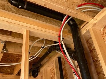 Pex Plumbing Pipes Exposed During Rough-In Stage Of Construction