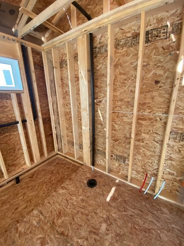 Pex Plumbing Pipes Exposed During Rough-In Stage Of Construction In Airdrie,AB