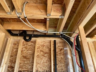 Pex Plumbing Pipes Exposed During Rough-In Stage Of Construction