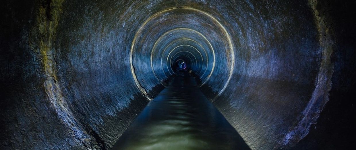 Using sewer camera, image displayed inside plumbing pipes.