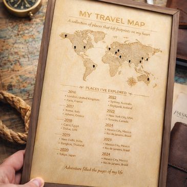 A framed travel map listing places explored from 2016 to 2024 with marked locations on a world map.