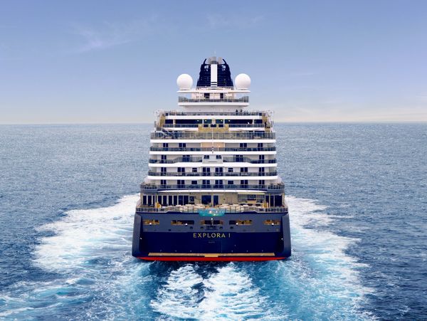 Luxury cruise ship Explora Journeys I sailing on calm blue waters.