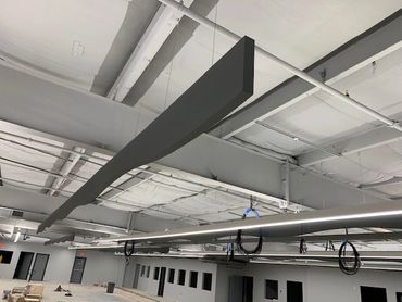 Acoustic panels customized by  Chroma Collections absorb sound in exposed ceiling