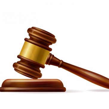 Wooden judge's gavel with brass band.
